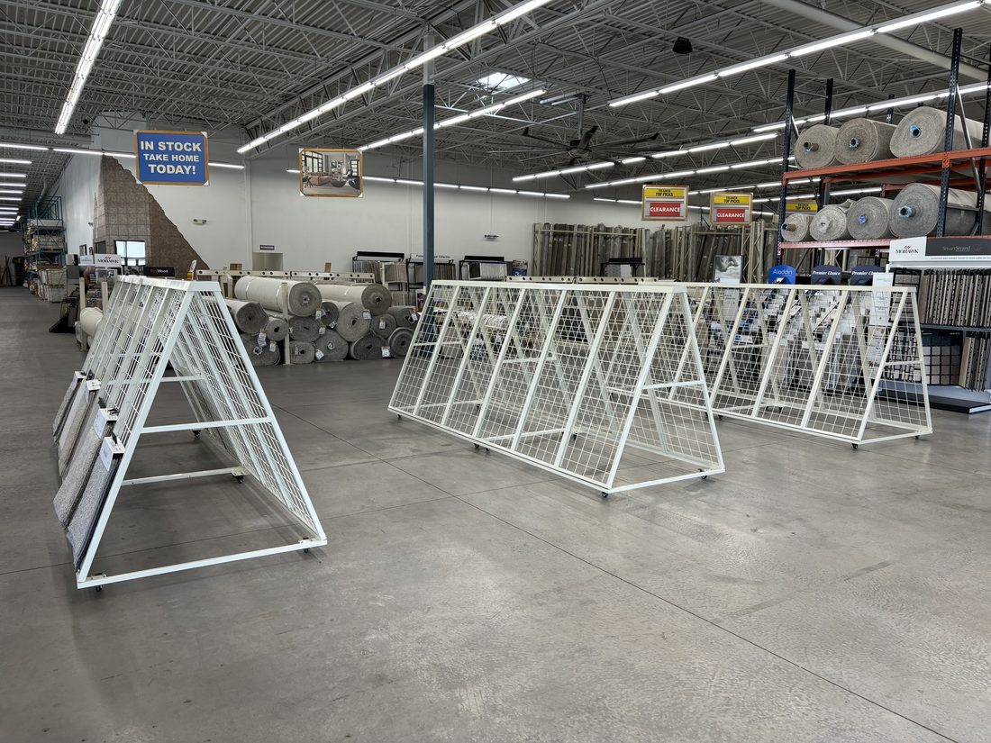 Multiple fabricated metal frames lined up in a shop.